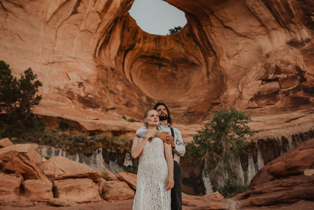 Bride and Groom eloping at Corona Arch, Utah.